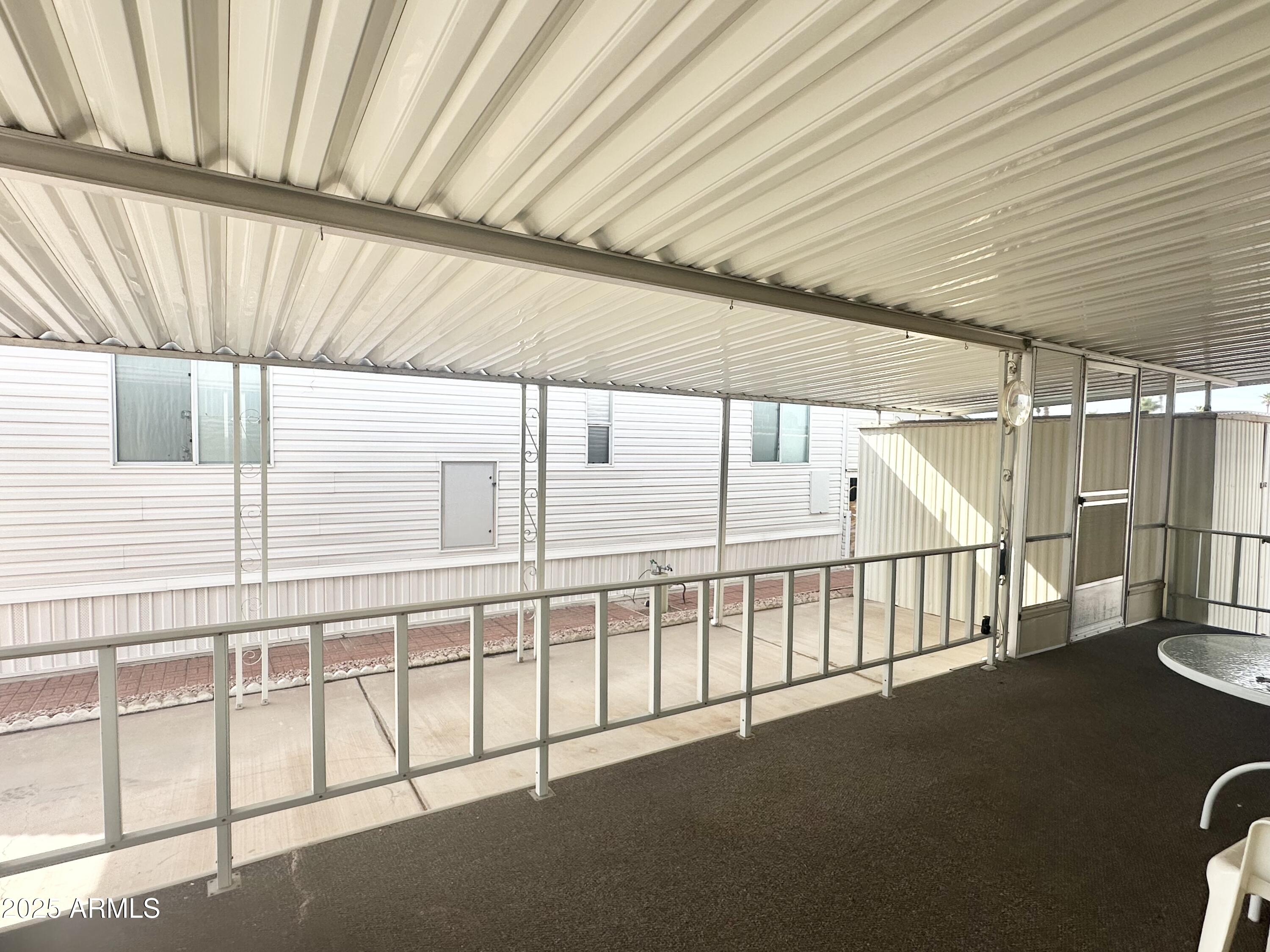 3710 South Goldfield Road, Unit 1052 Apache Junction, AZ 85119 - Photo 9 of 48 a view of a porch