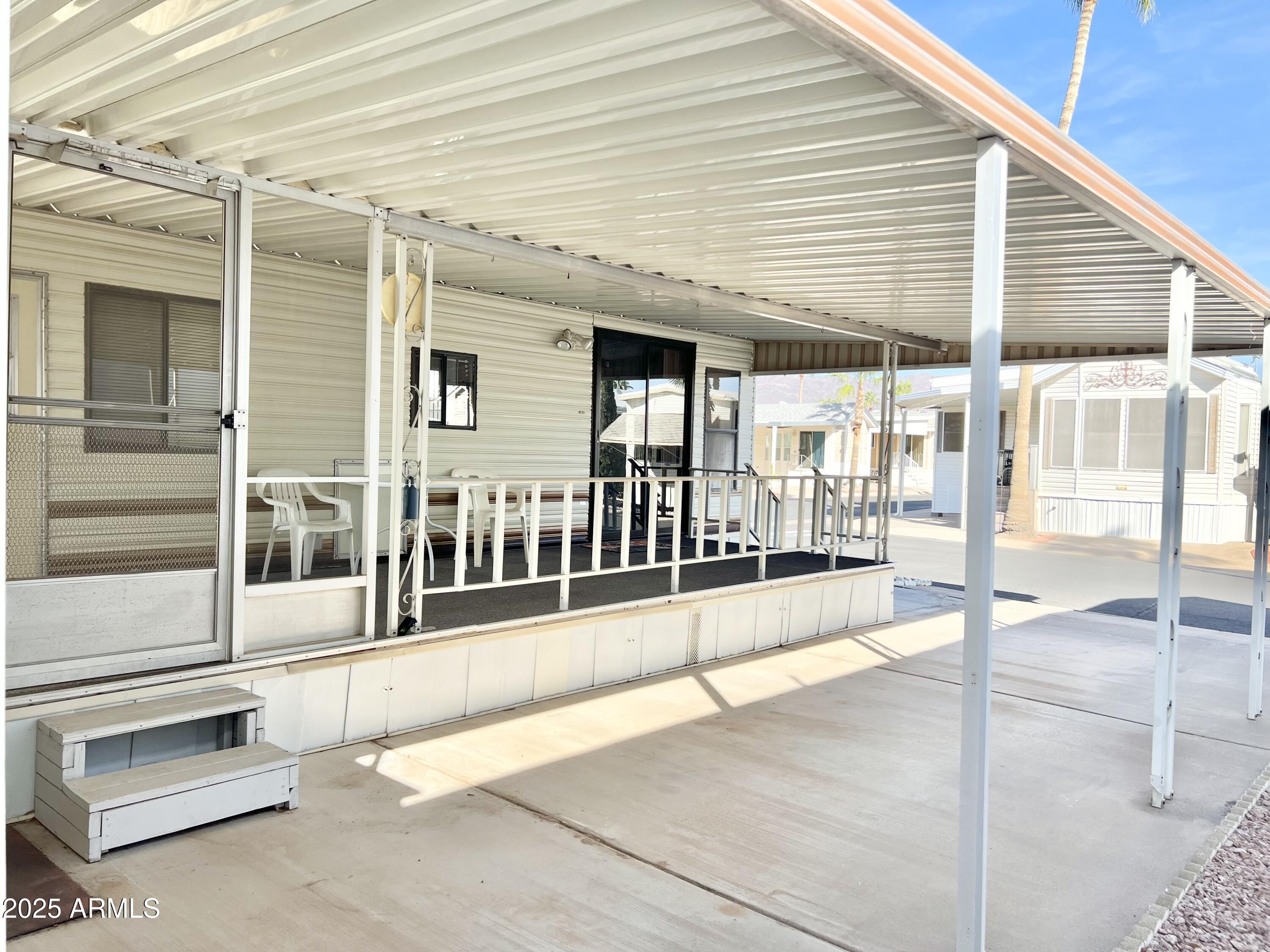 3710 South Goldfield Road, Unit 1052 Apache Junction, AZ 85119 - Photo 10 of 48 a view of a building with a porch