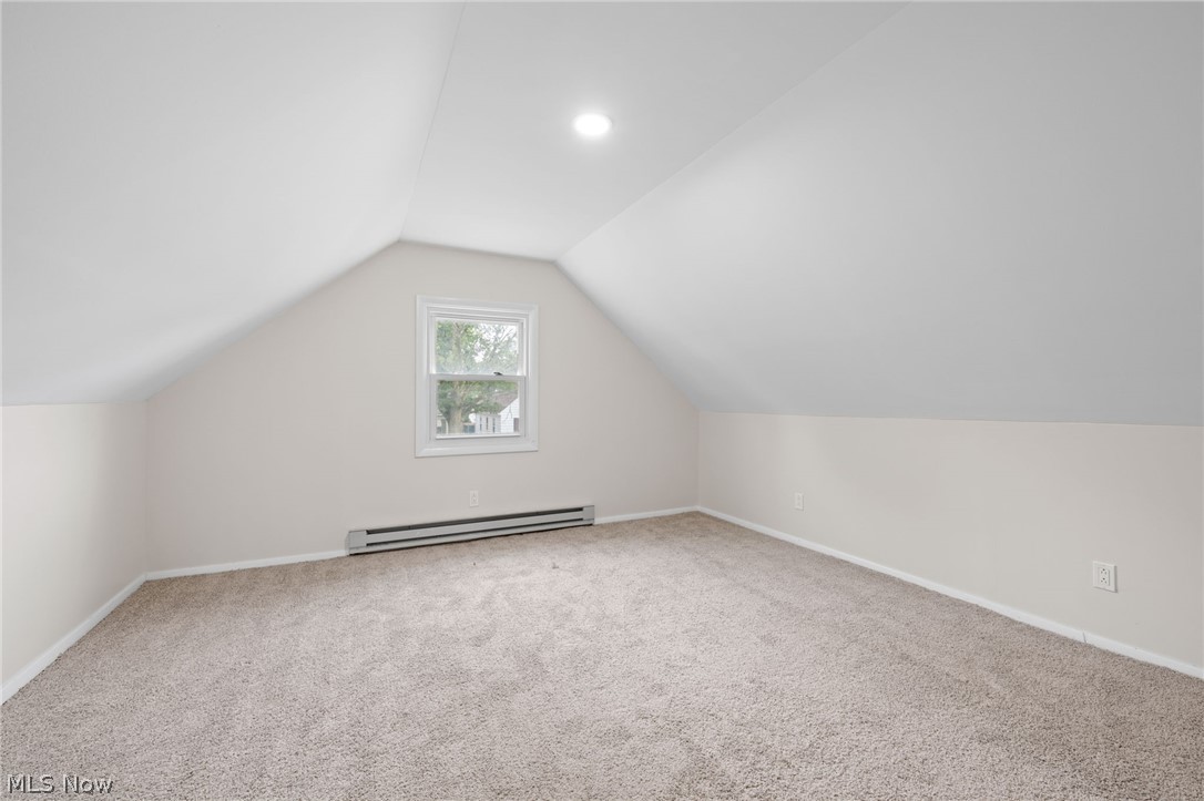 18409 Homeway Road Cleveland, OH 44135 - Photo 17 of 25 Bedroom featuring carpet flooring, baseboard heating, and lofted ceiling