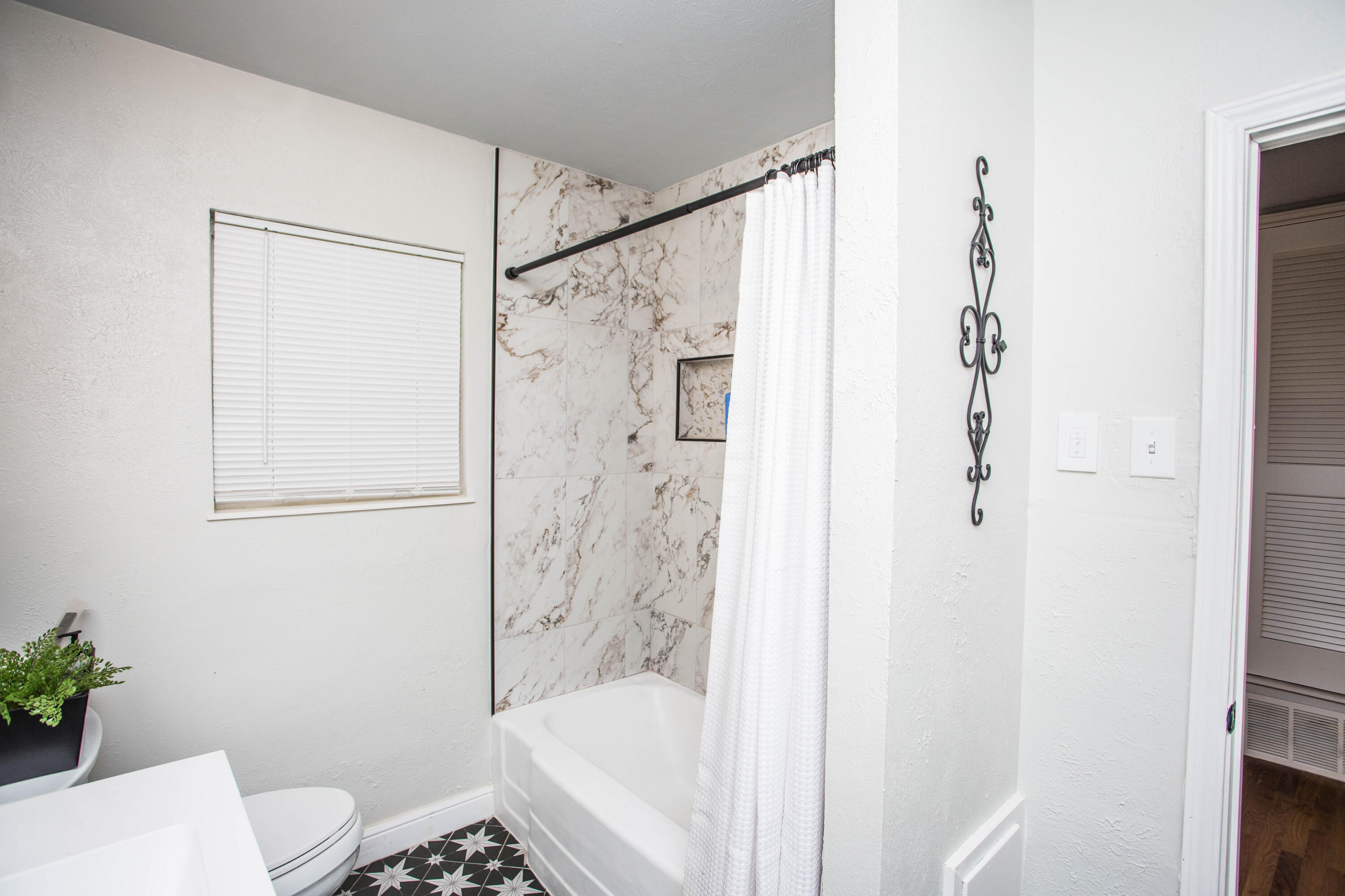 2712 30th Street Lubbock, TX 79410 - Photo 11 of 26 a bathroom with a shower and a toilet