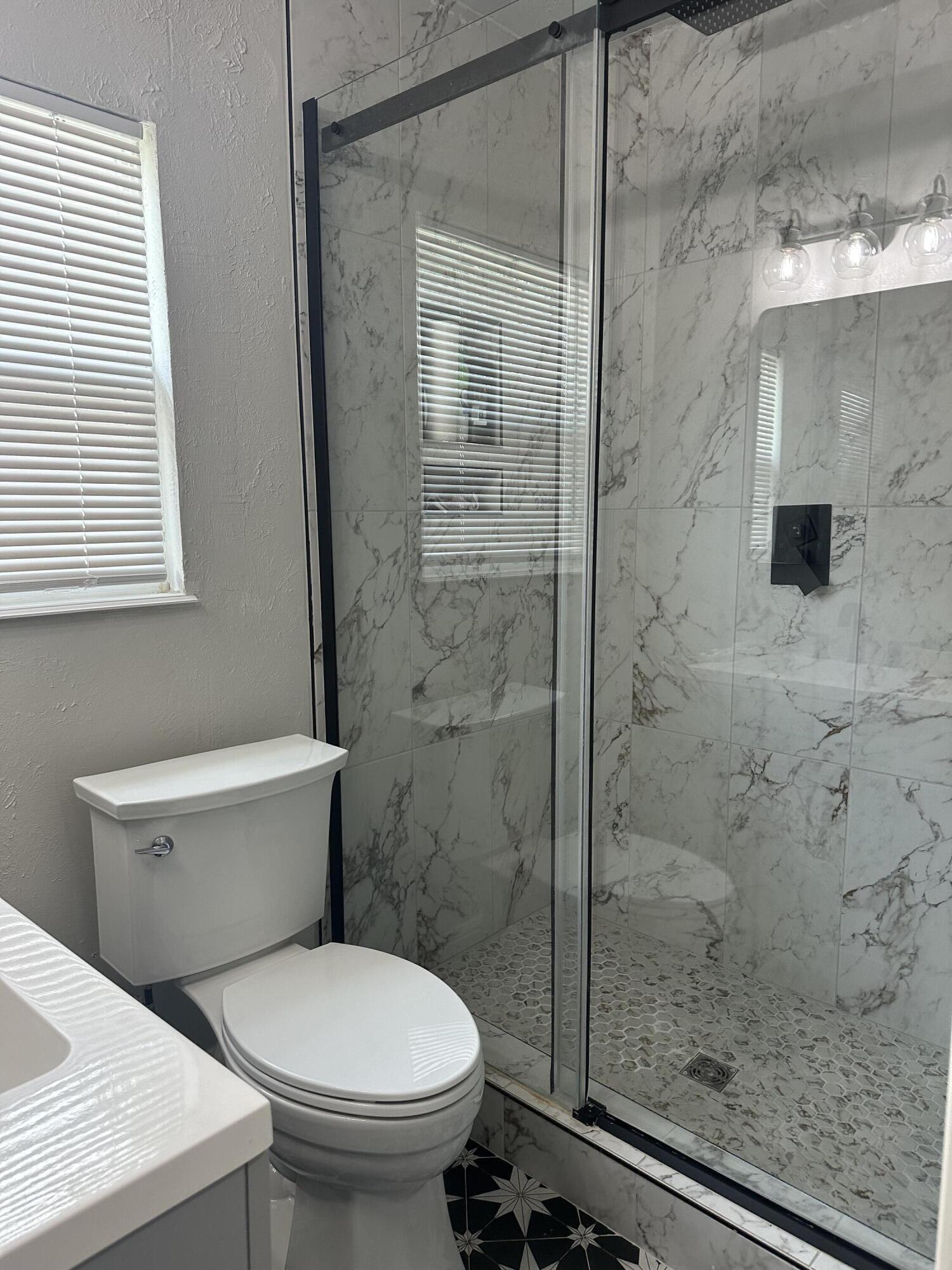 2712 30th Street Lubbock, TX 79410 - Photo 17 of 26 a bathroom with a toilet and a shower