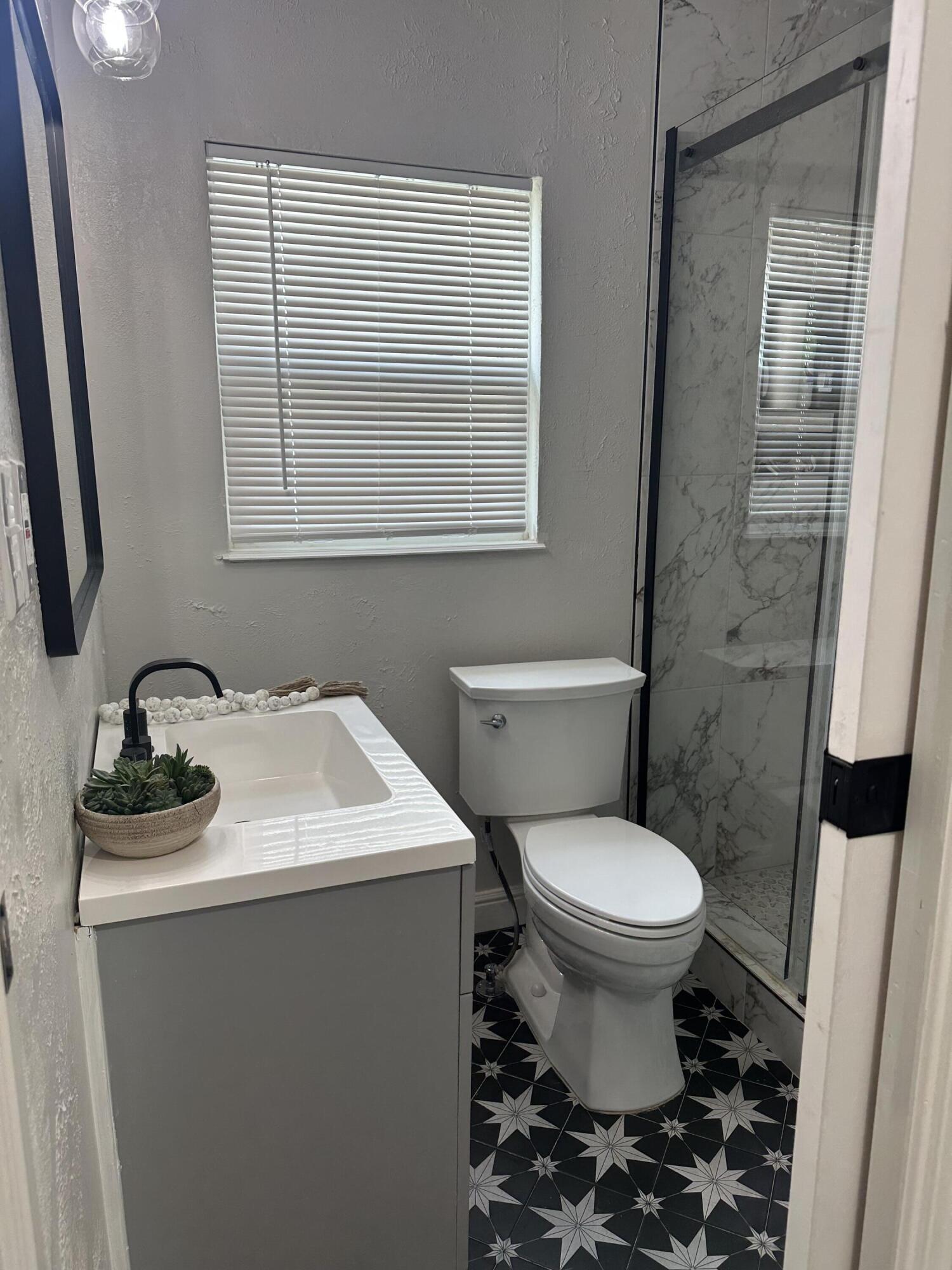 2712 30th Street Lubbock, TX 79410 - Photo 18 of 26 a bathroom with a sink toilet and a mirror