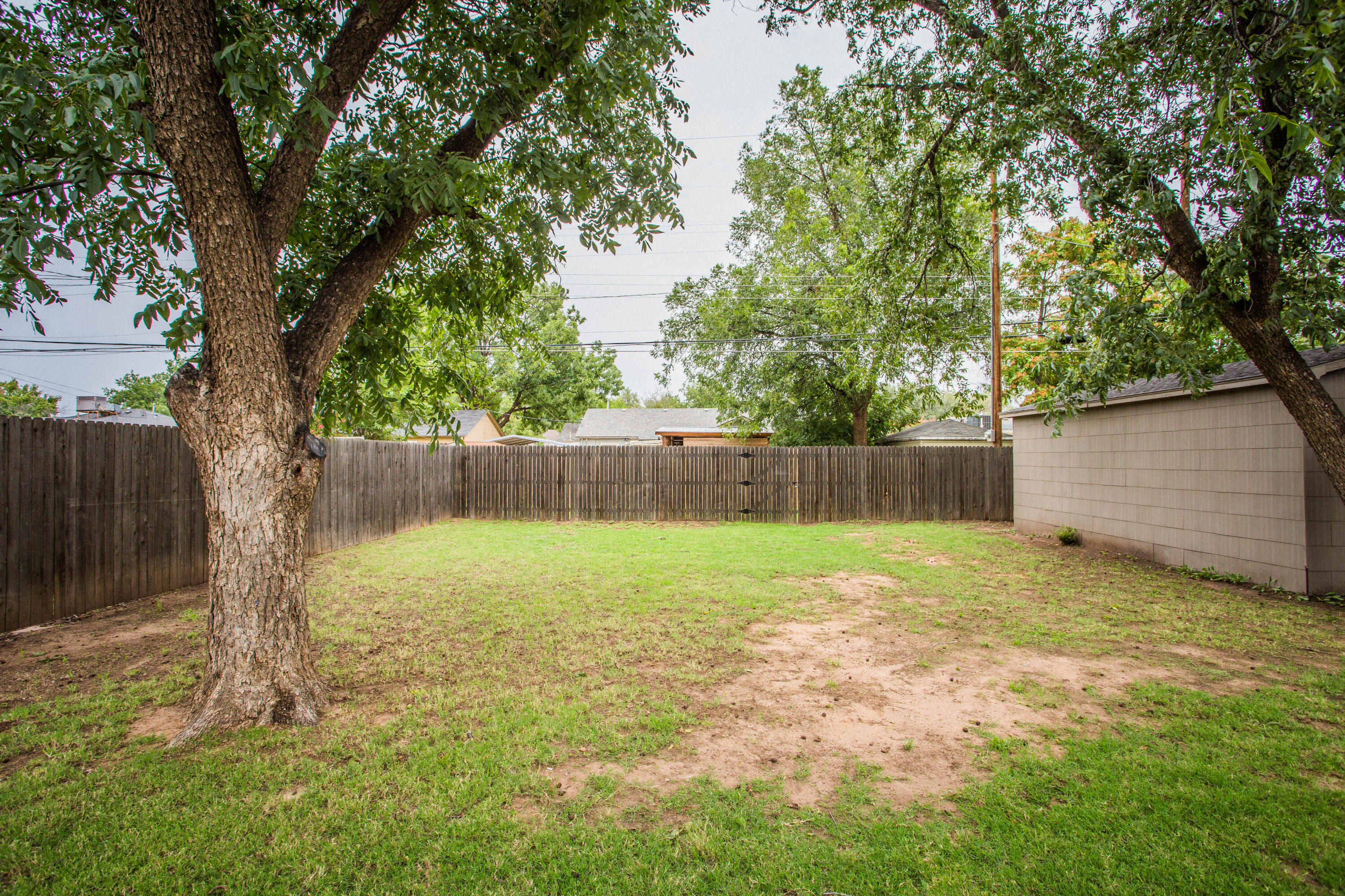 2712 30th Street Lubbock, TX 79410 - Photo 23 of 26 a view of a yard with a tree