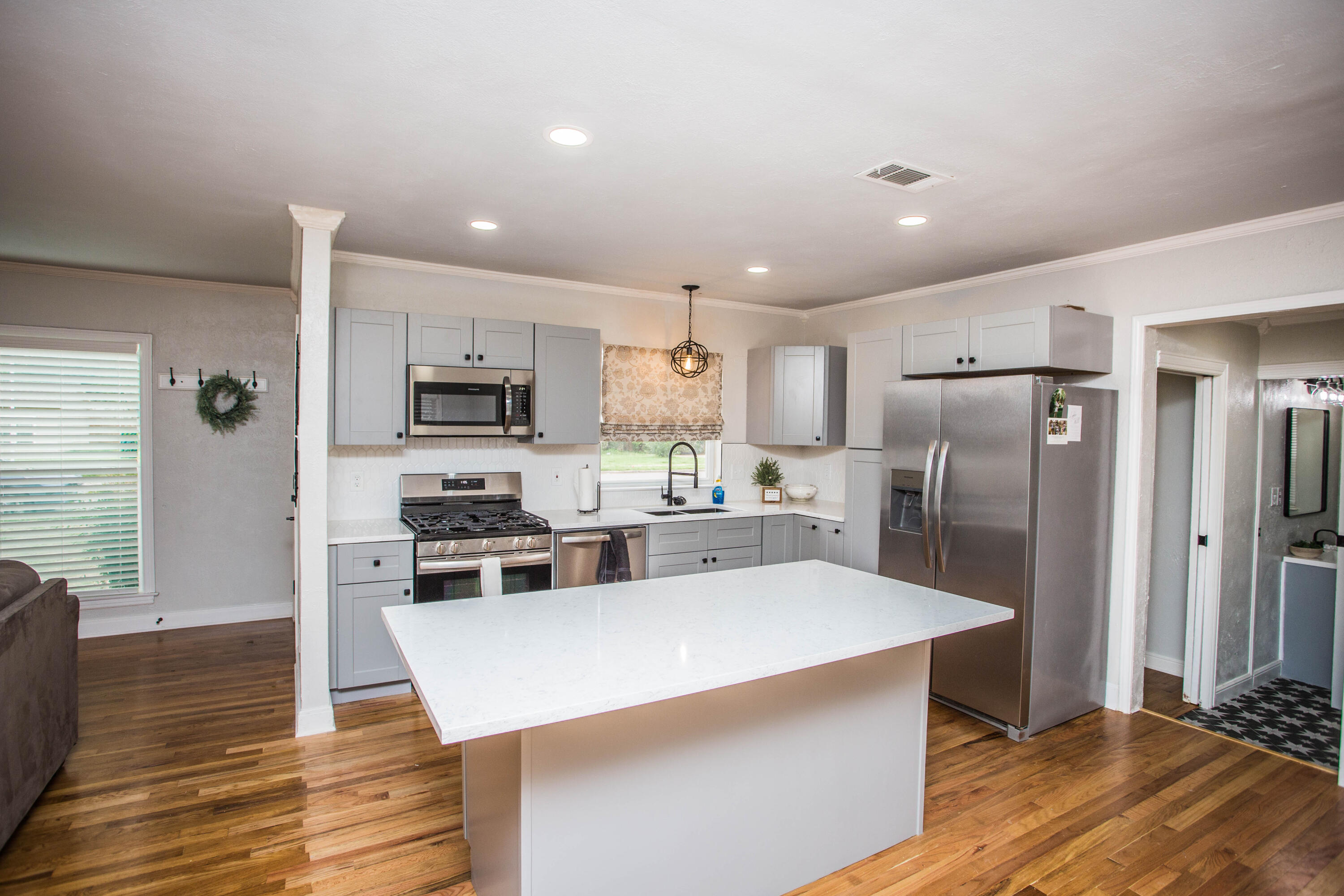 2712 30th Street Lubbock, TX 79410 - Photo 6 of 26 a kitchen with stainless steel appliances a refrigerator and a stove top oven