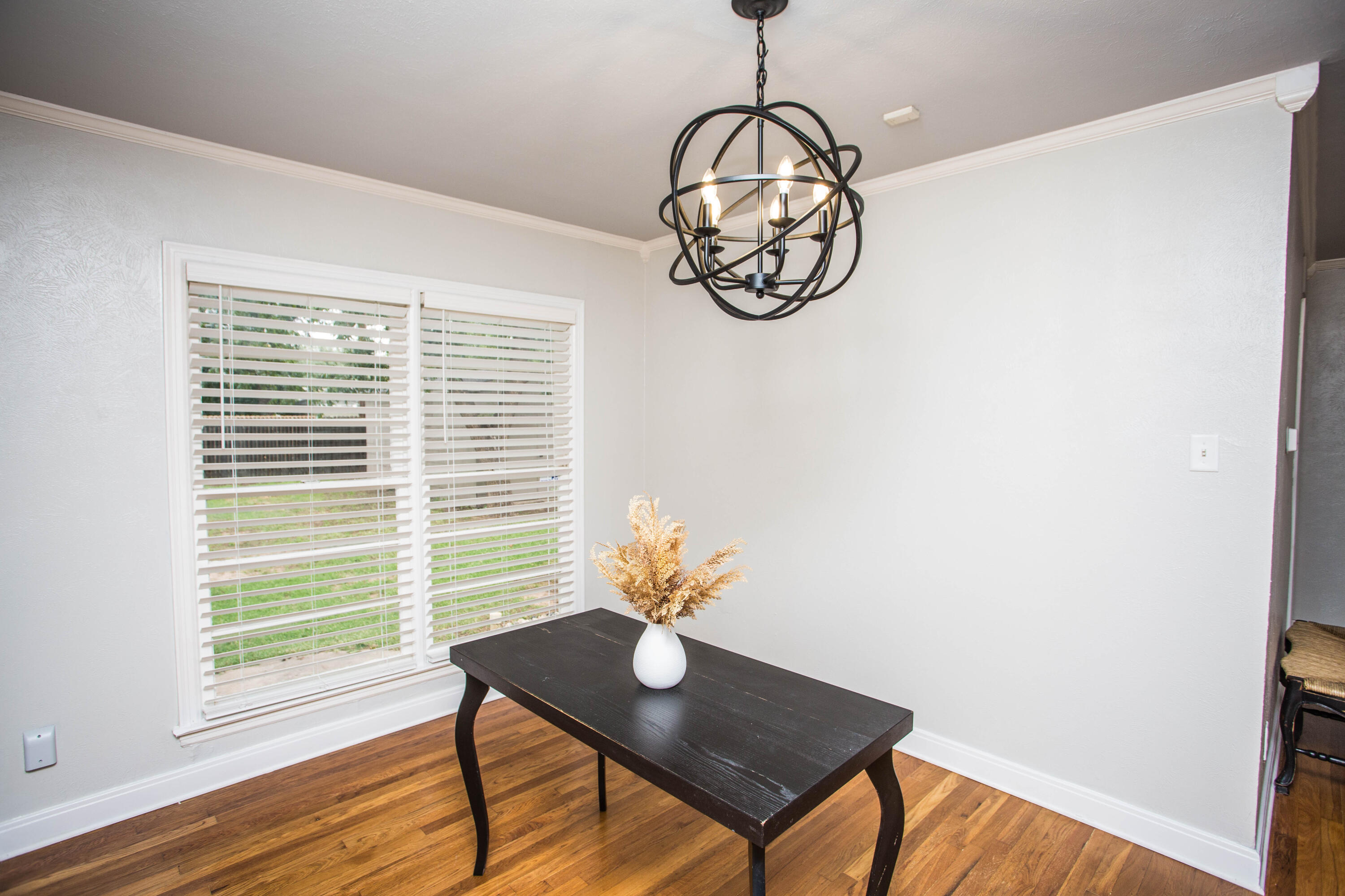 2712 30th Street Lubbock, TX 79410 - Photo 9 of 26 a view of a room with a table chairs and wooden floor