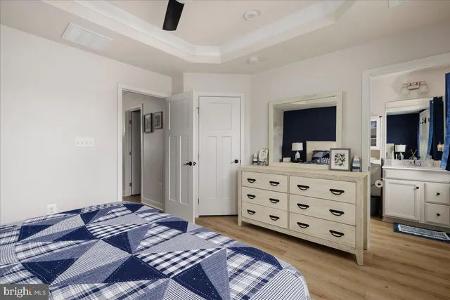 a bedroom with a bed and a flat tv screen on dresser