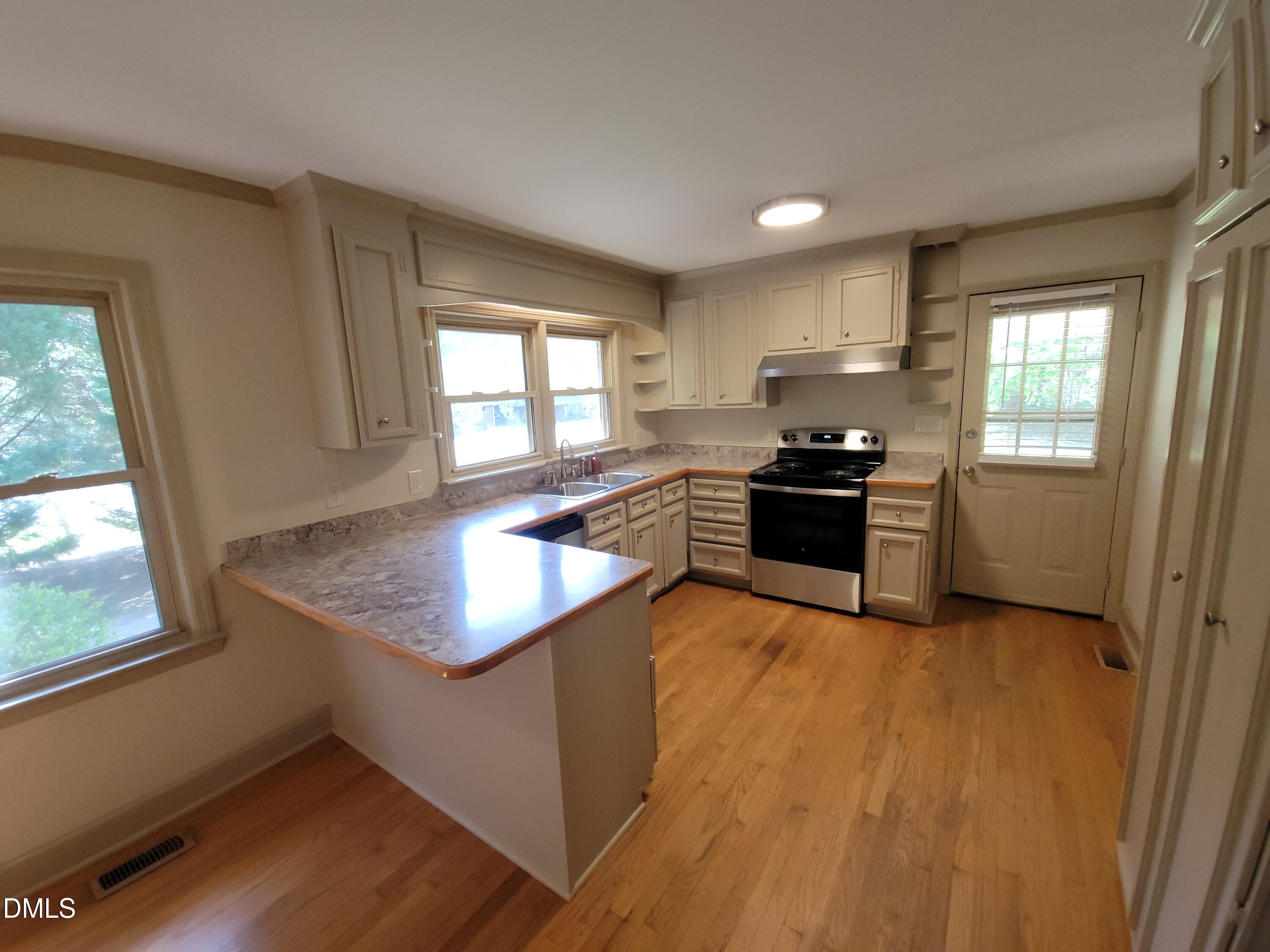 7000 Holly Springs Road Raleigh, NC 27606 - Photo 10 of 24 a kitchen with granite countertop a stove and a sink