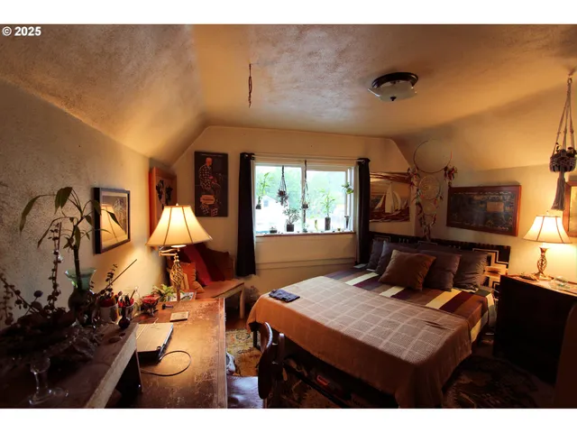 a view of a workspace with furniture and a potted plant
