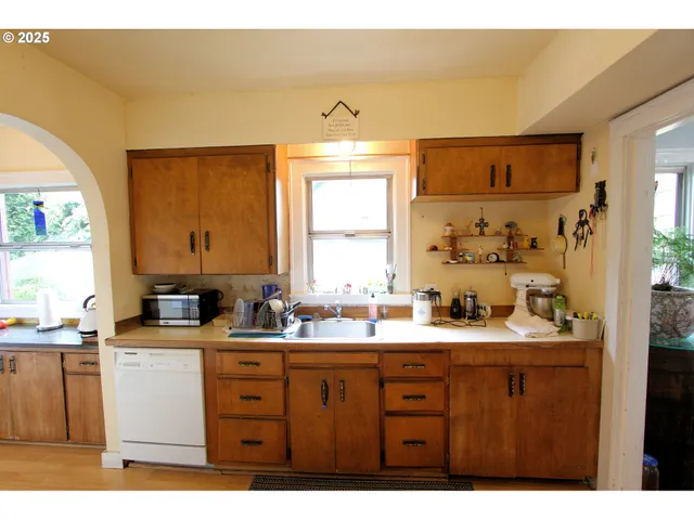 a kitchen with stainless steel appliances kitchen island granite countertop a stove a sink and a refrigerator