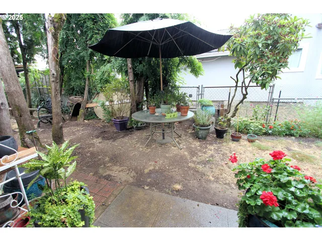 a view of a patio with table and chairs and potted plants