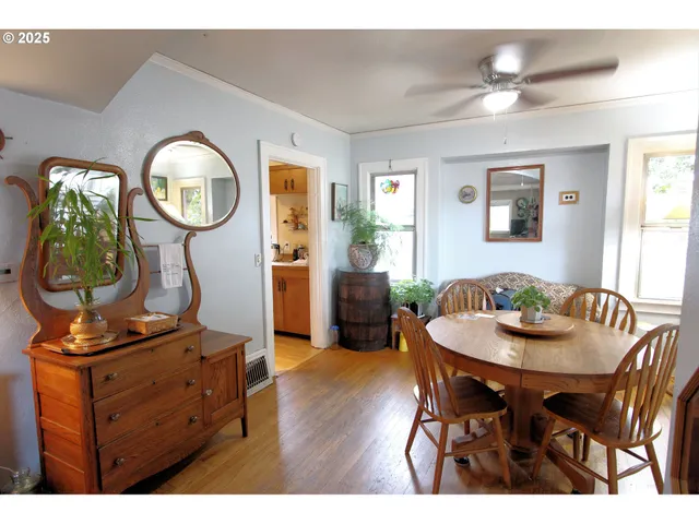 a dining room with furniture a mirror and wooden floor