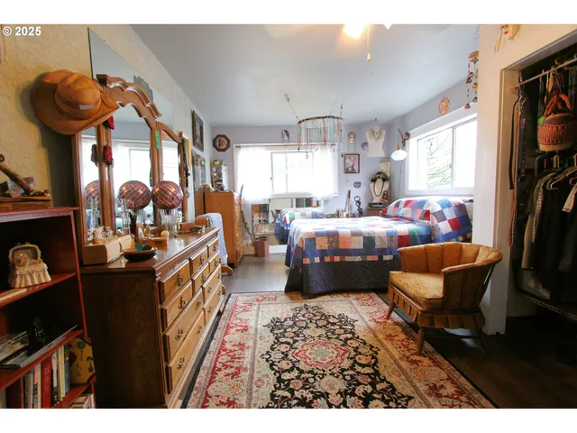 a living room with furniture a window and a flat screen tv