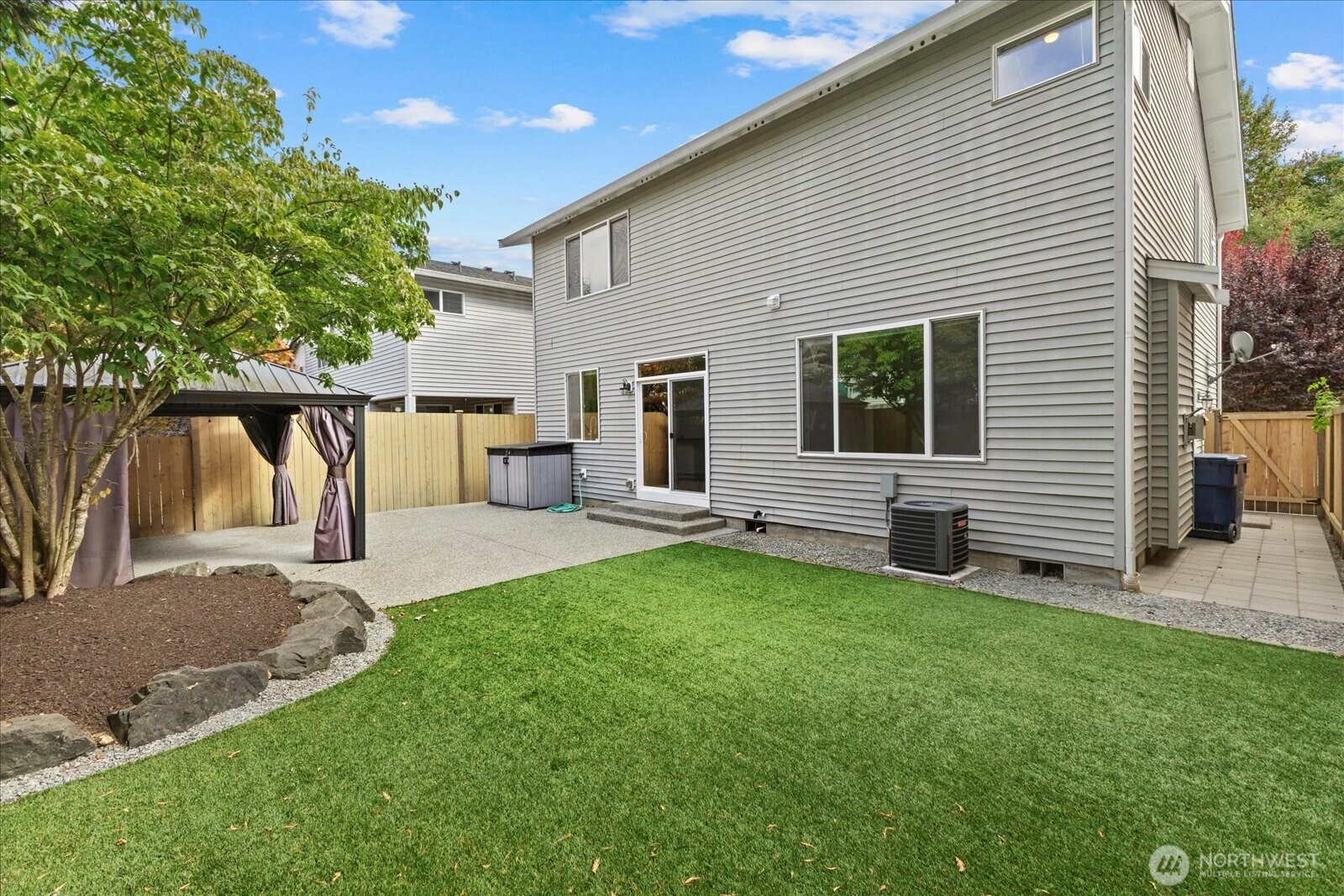 14912 48th Avenue Southeast Bothell, WA 98012 - Photo 29 of 40 a view of a backyard with table and chairs and a large tree