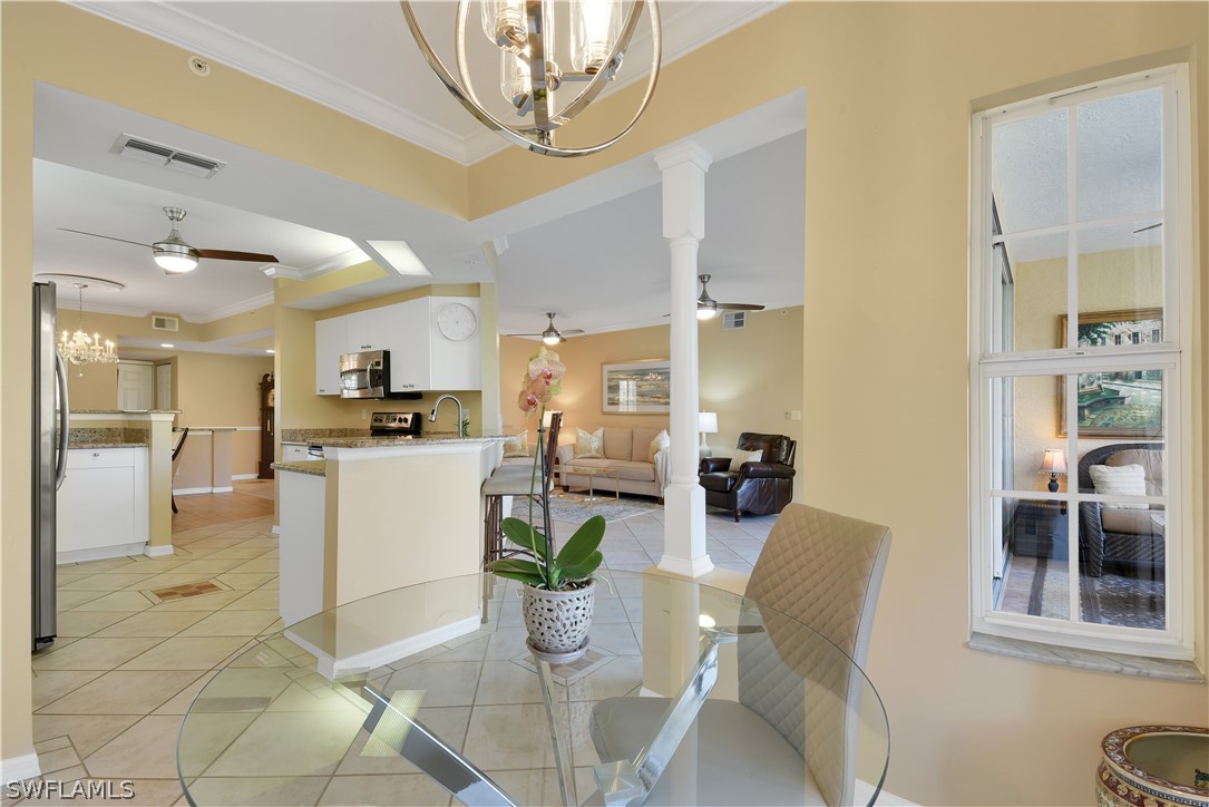 6838 Lantana Bridge Road, Unit 102 Naples, FL 34109 - Photo 11 of 34 a living room with furniture a dining table and kitchen view