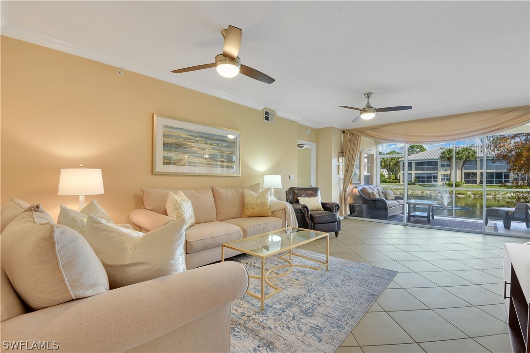 6838 Lantana Bridge Road, Unit 102 Naples, FL 34109 - Photo 13 of 34 a living room with furniture and a large window