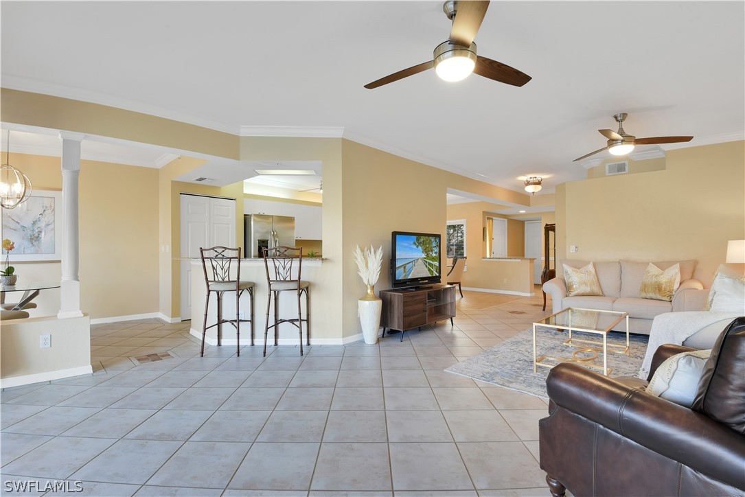 6838 Lantana Bridge Road, Unit 102 Naples, FL 34109 - Photo 14 of 34 a living room with furniture and a flat screen tv