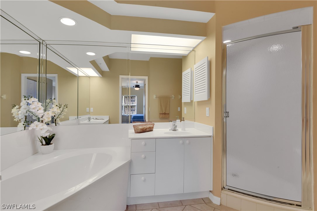 6838 Lantana Bridge Road, Unit 102 Naples, FL 34109 - Photo 17 of 34 a bathroom with a double vanity sink mirror and