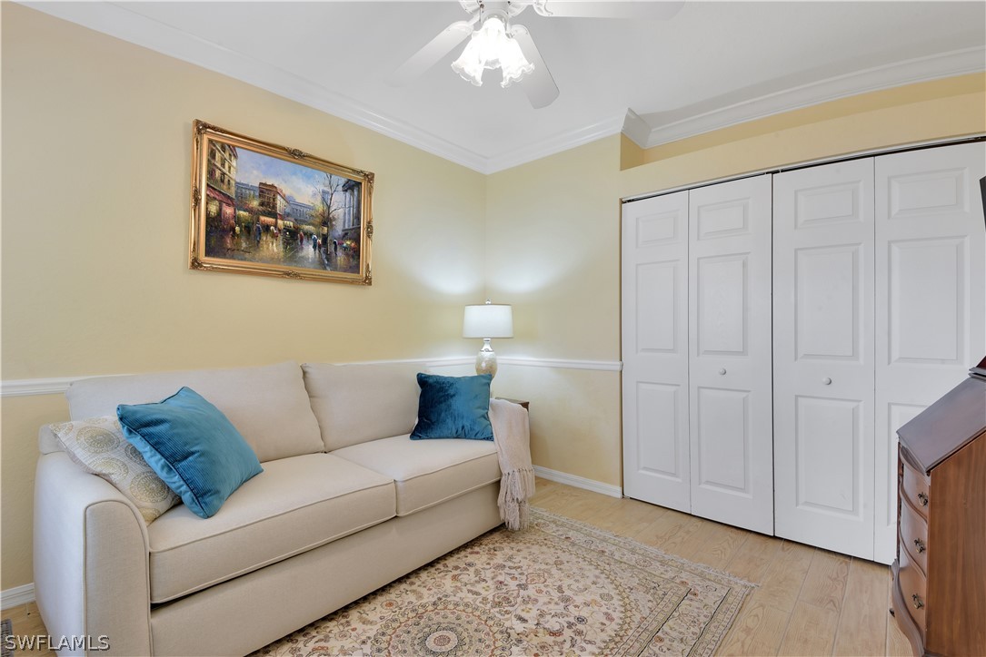 6838 Lantana Bridge Road, Unit 102 Naples, FL 34109 - Photo 19 of 34 a living room with furniture and a chandelier