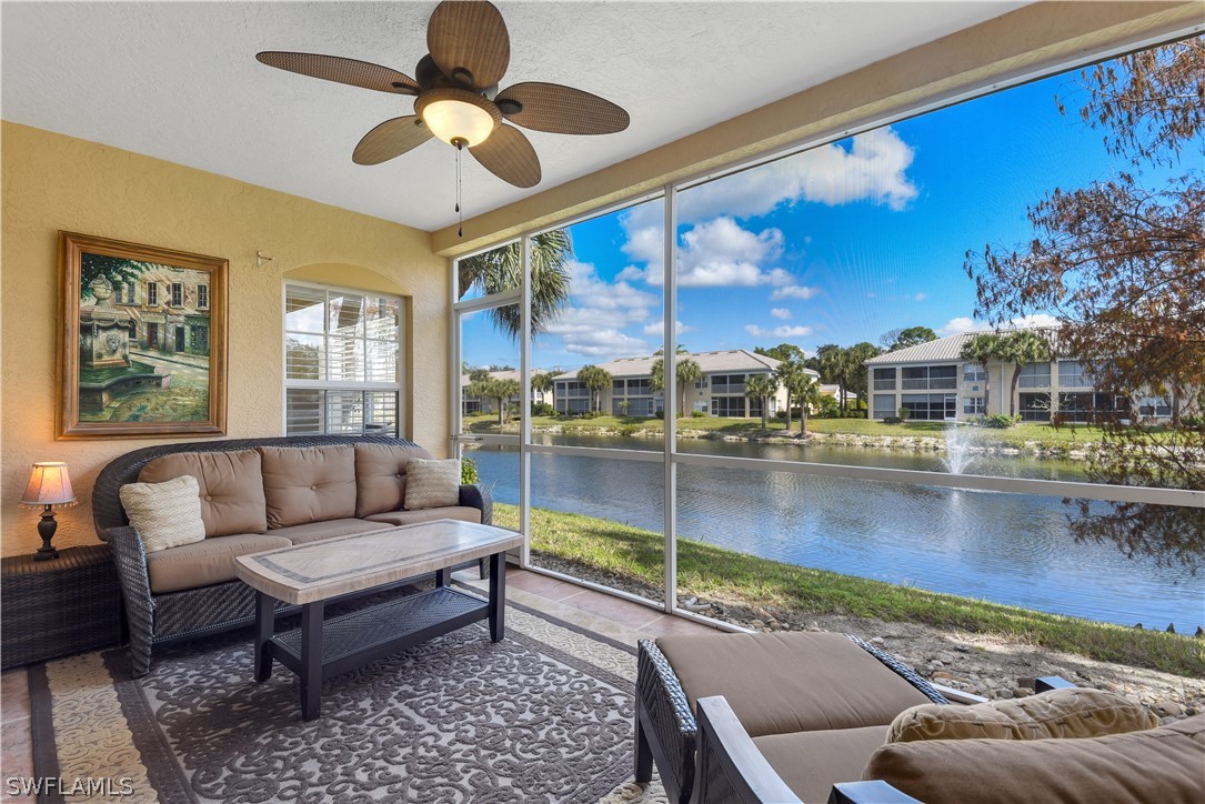 6838 Lantana Bridge Road, Unit 102 Naples, FL 34109 - Photo 23 of 34 a living room with furniture and a floor to ceiling window