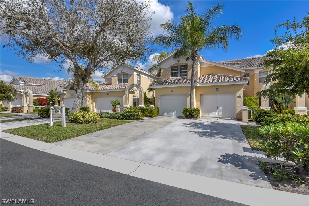 6838 Lantana Bridge Road, Unit 102 Naples, FL 34109 - Photo 6 of 34 a front view of a house with garden