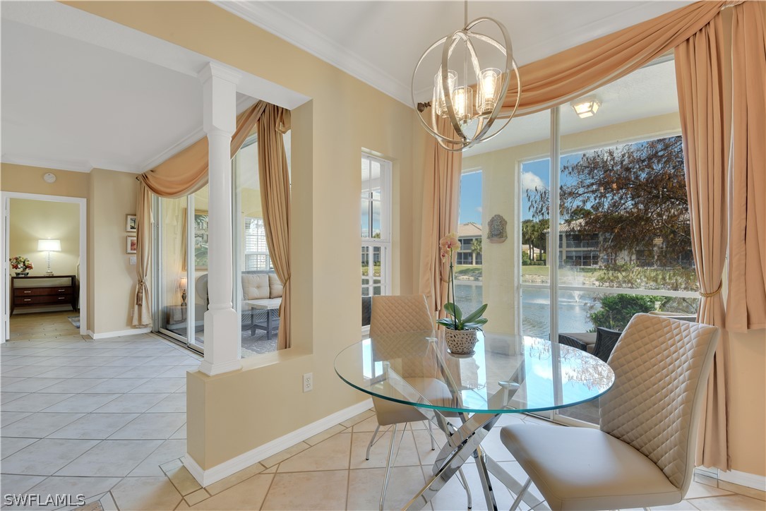 6838 Lantana Bridge Road, Unit 102 Naples, FL 34109 - Photo 7 of 34 a view of a dining room with furniture a chandelier and large windows