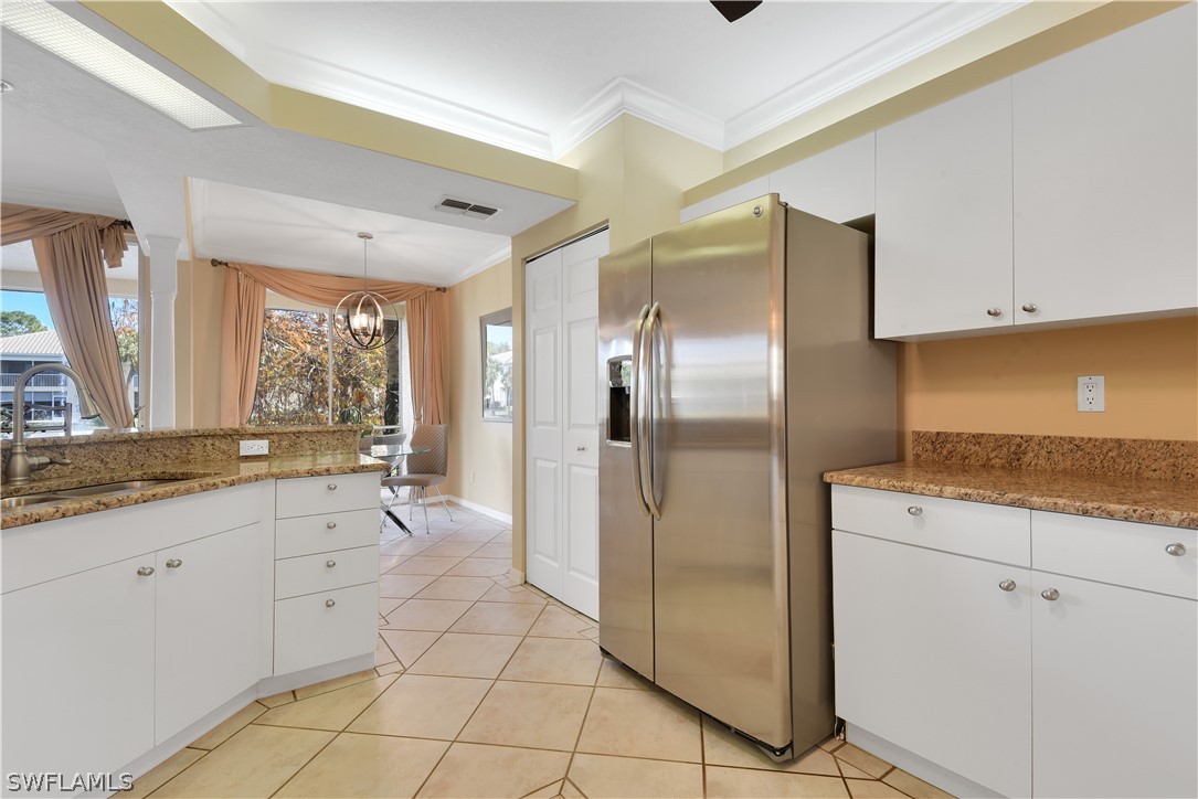6838 Lantana Bridge Road, Unit 102 Naples, FL 34109 - Photo 8 of 34 a large kitchen with a sink and cabinets