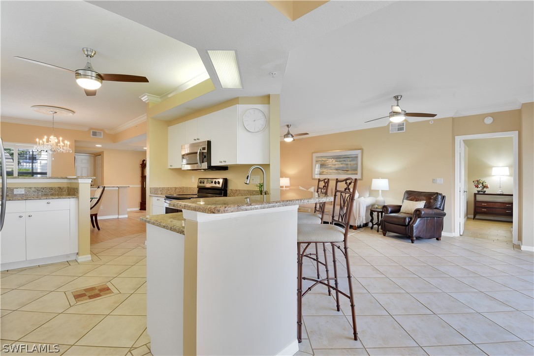 6838 Lantana Bridge Road, Unit 102 Naples, FL 34109 - Photo 9 of 34 a living room with furniture and kitchen view