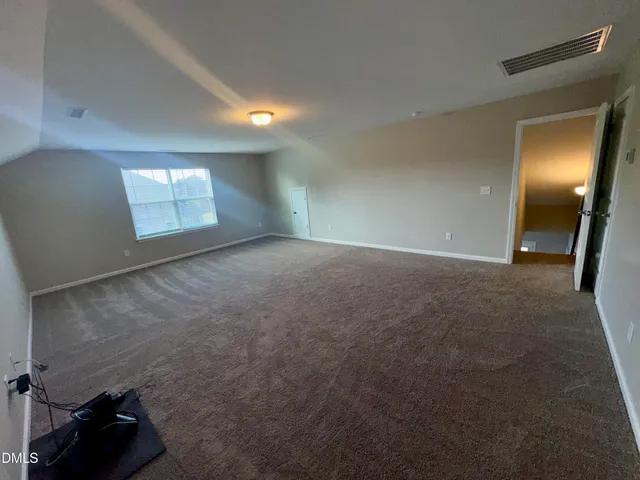 a view of a balcony with a floor to ceiling window and wooden fence