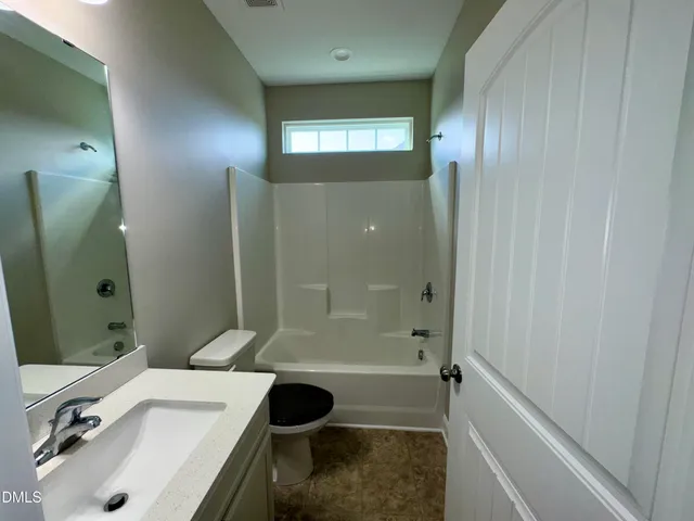 an empty room with windows and entrance