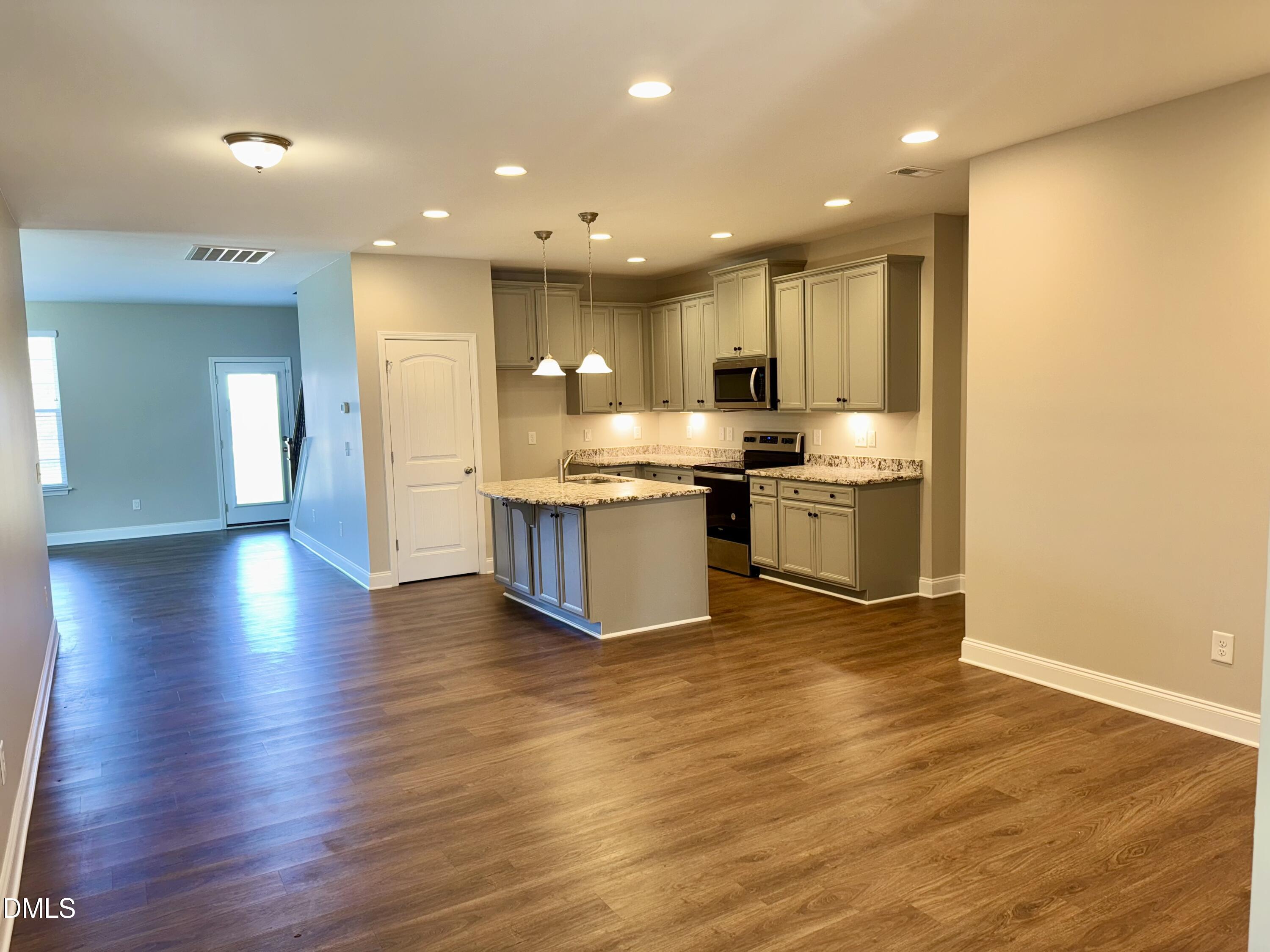 1946 Payne Road Haw River, NC 27258 - Photo 9 of 18 a view of kitchen with kitchen island wooden floor and stainless steel appliances
