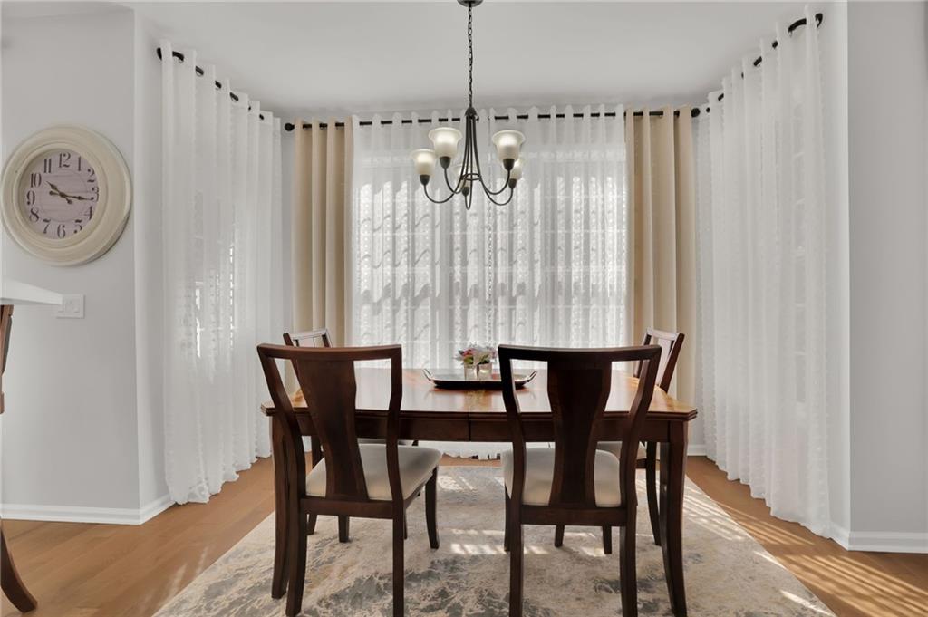 520 Ruby Forest Parkway Suwanee, GA 30024 - Photo 12 of 37 a view of a dining room with furniture and window
