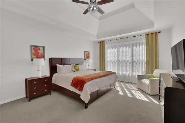 a spacious bedroom with a bed and a large window