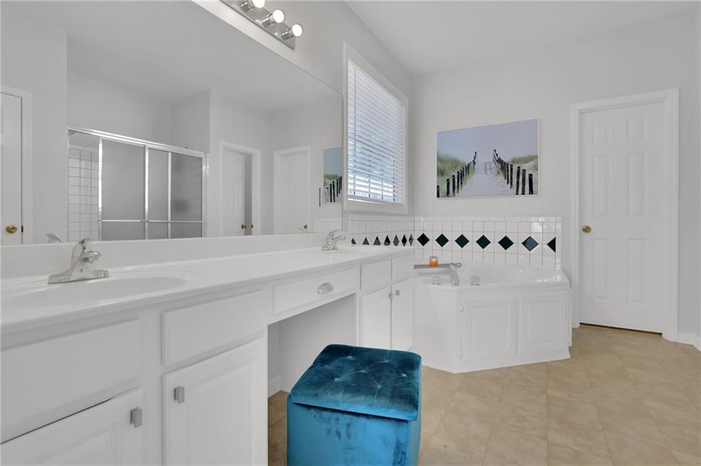 520 Ruby Forest Parkway Suwanee, GA 30024 - Photo 16 of 37 a bathroom with a bathtub and a sink