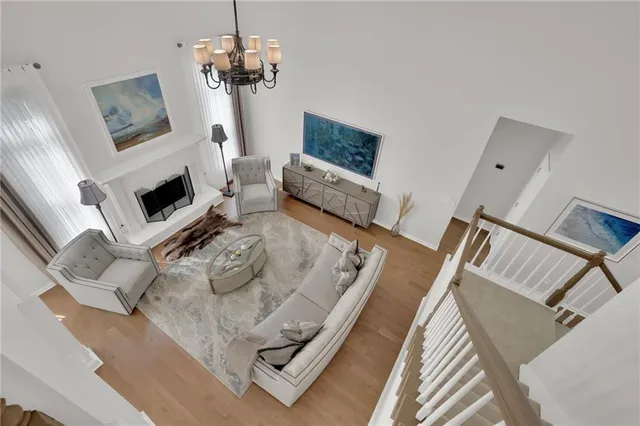 a living room with furniture a fireplace and a chandelier
