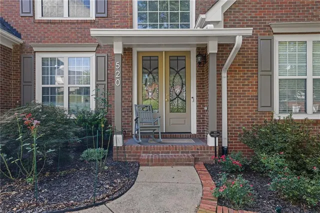 a view of a brick house with plants