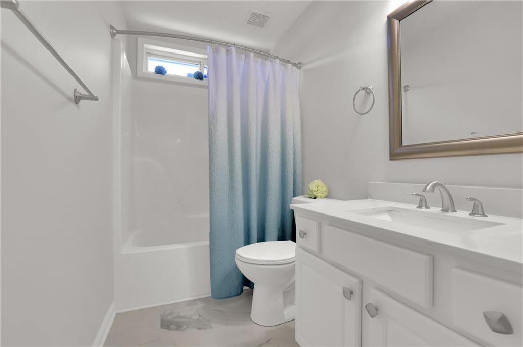 520 Ruby Forest Parkway Suwanee, GA 30024 - Photo 21 of 37 a bathroom with a sink a toilet and shower