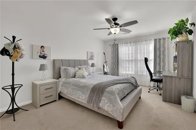 a spacious bedroom with a bed and a chandelier