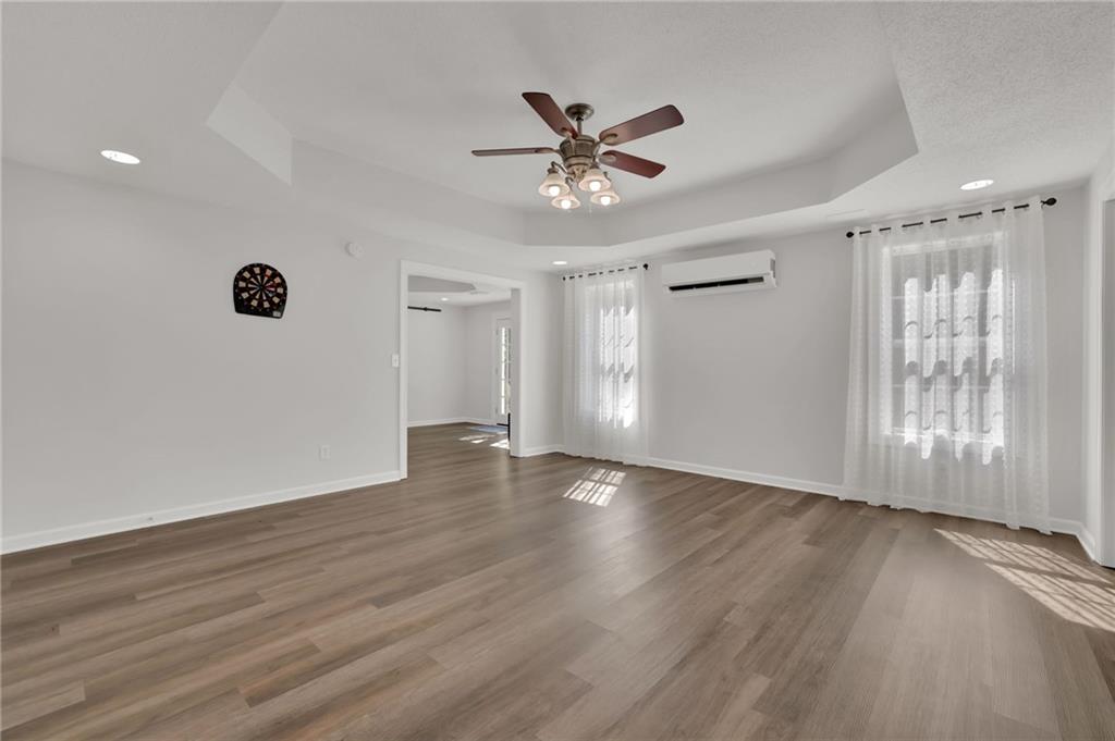 520 Ruby Forest Parkway Suwanee, GA 30024 - Photo 24 of 37 a view of an empty room with wooden floor and a window
