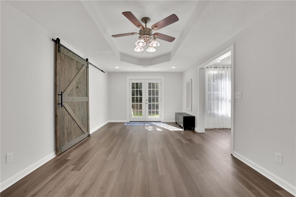 520 Ruby Forest Parkway Suwanee, GA 30024 - Photo 27 of 37 an empty room with wooden floor and windows