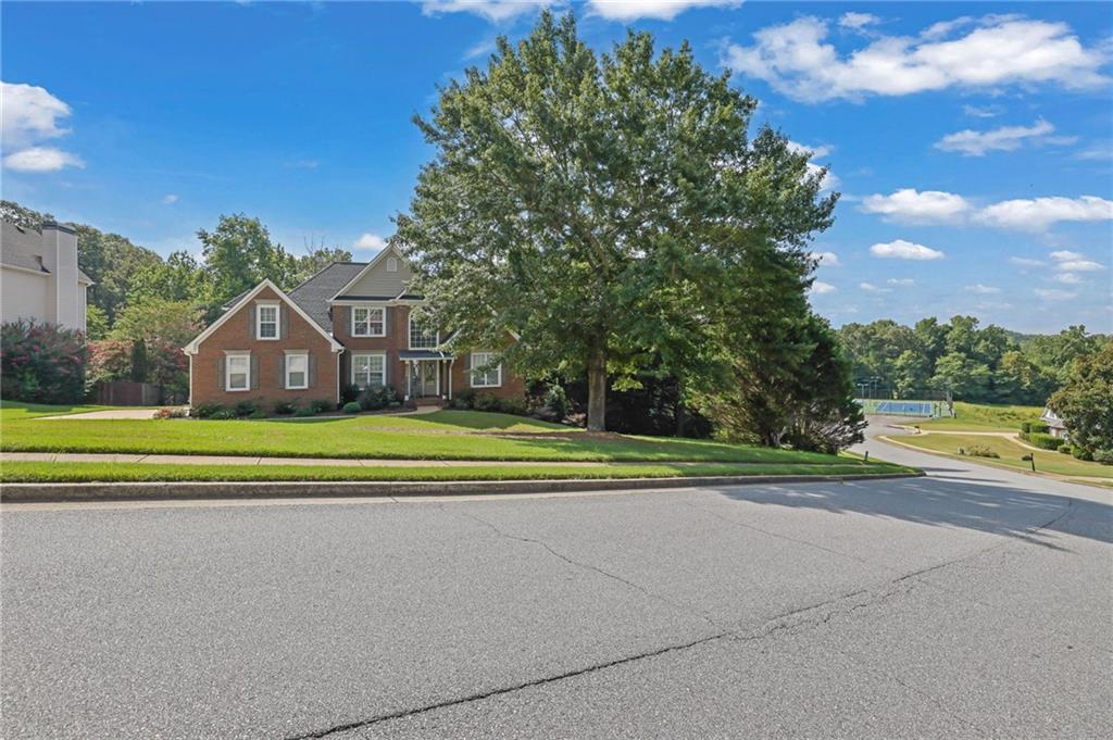 520 Ruby Forest Parkway Suwanee, GA 30024 - Photo 36 of 37 a view of a house with a big yard and a large tree