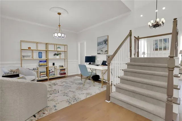 a view of hall way with furniture and stairs