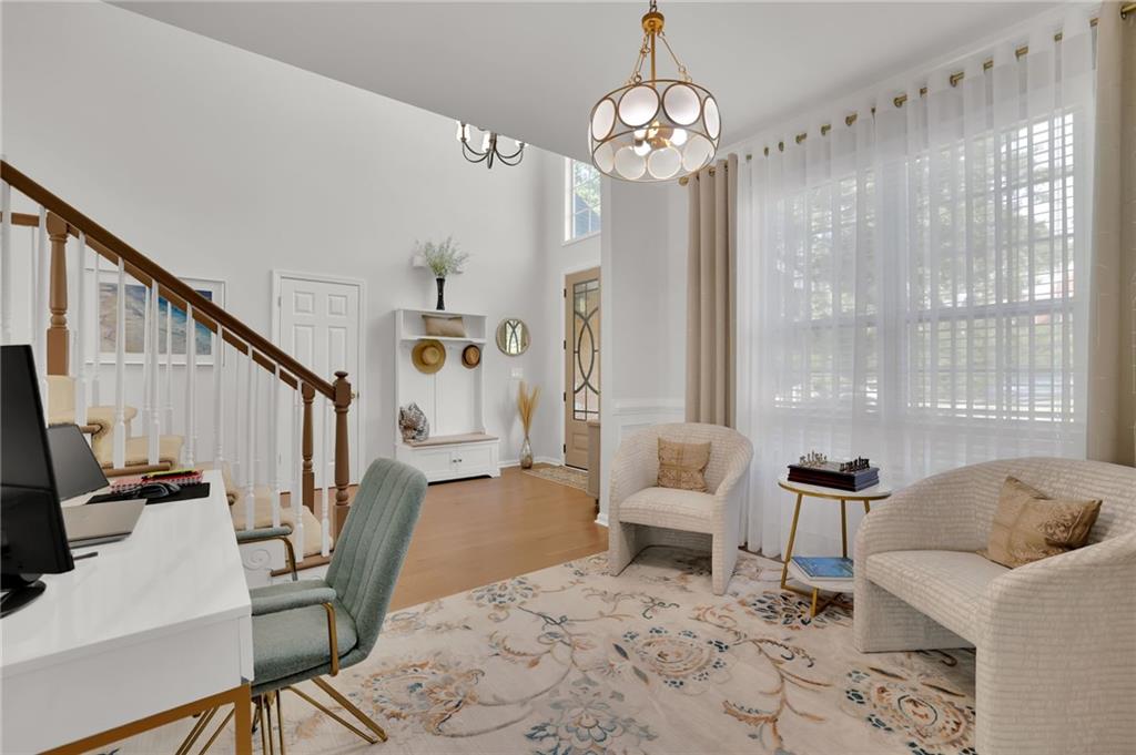 520 Ruby Forest Parkway Suwanee, GA 30024 - Photo 5 of 37 a living room with furniture and a chandelier