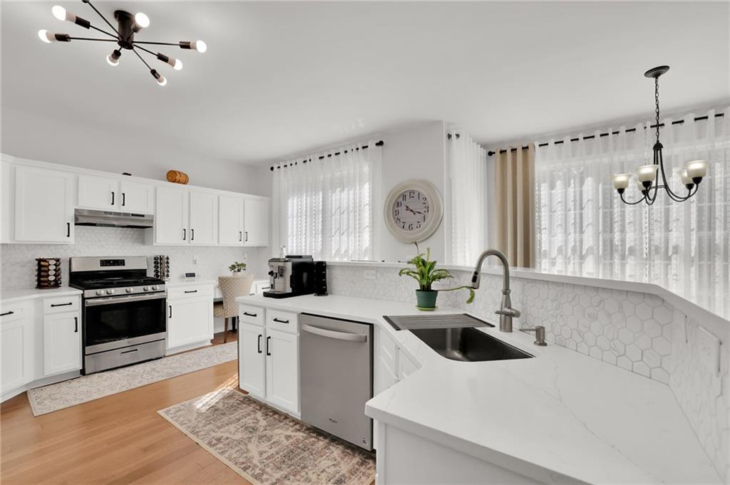 520 Ruby Forest Parkway Suwanee, GA 30024 - Photo 8 of 37 a kitchen with a sink a stove and cabinets