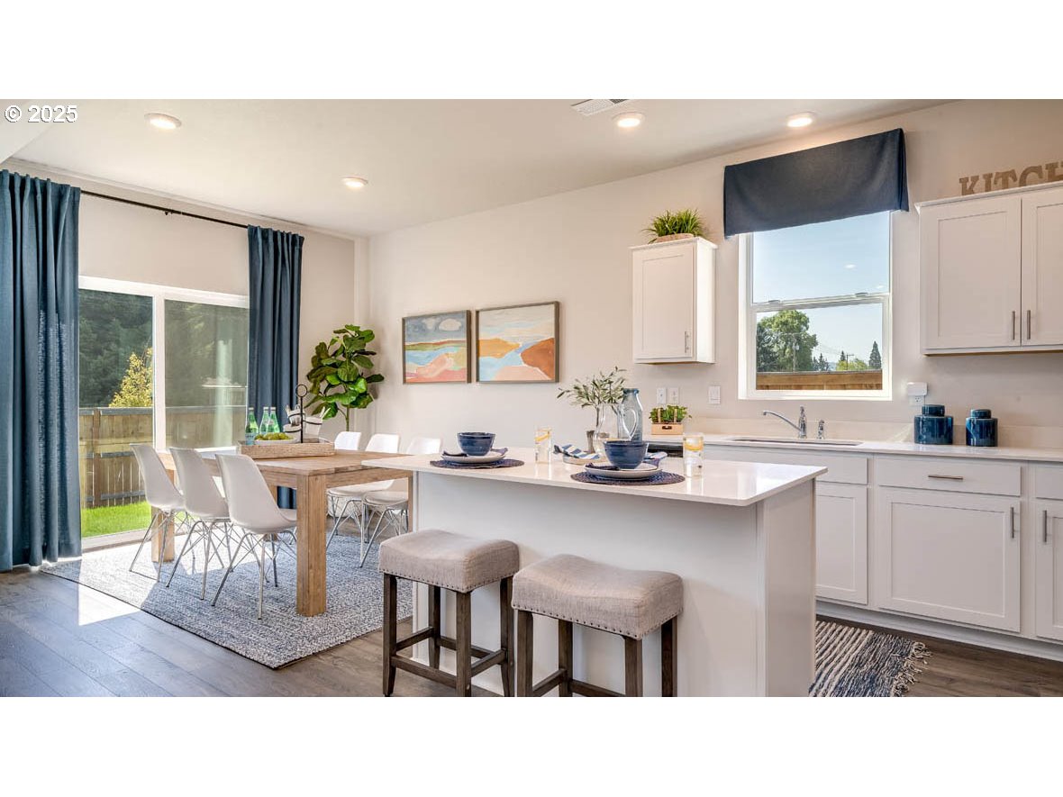 2343 30th Place Springfield, OR 97477 - Photo 9 of 29 a kitchen with a table chairs sink and cabinets