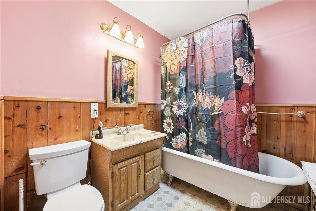 48 Bloomfield Avenue Edison, NJ 08837 - Photo 13 of 21 a bathroom with a sink a toilet and mirror