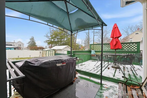 a view of a patio with table and chairs under an umbrella