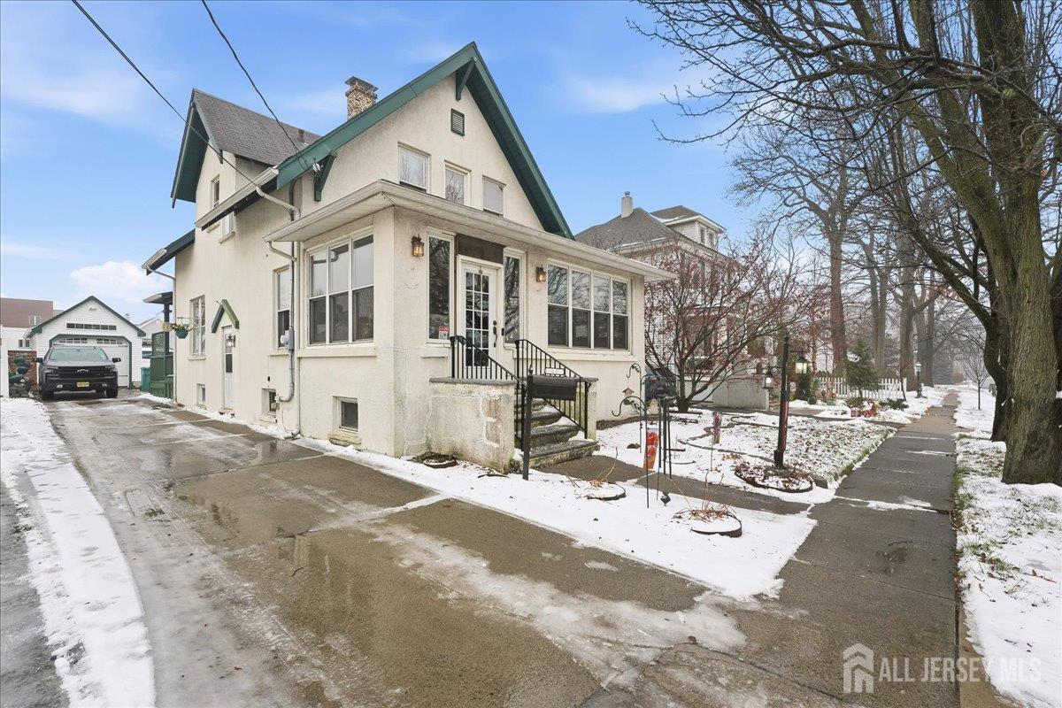 48 Bloomfield Avenue Edison, NJ 08837 - Photo 2 of 21 a view of a white house with a yard covered in snow