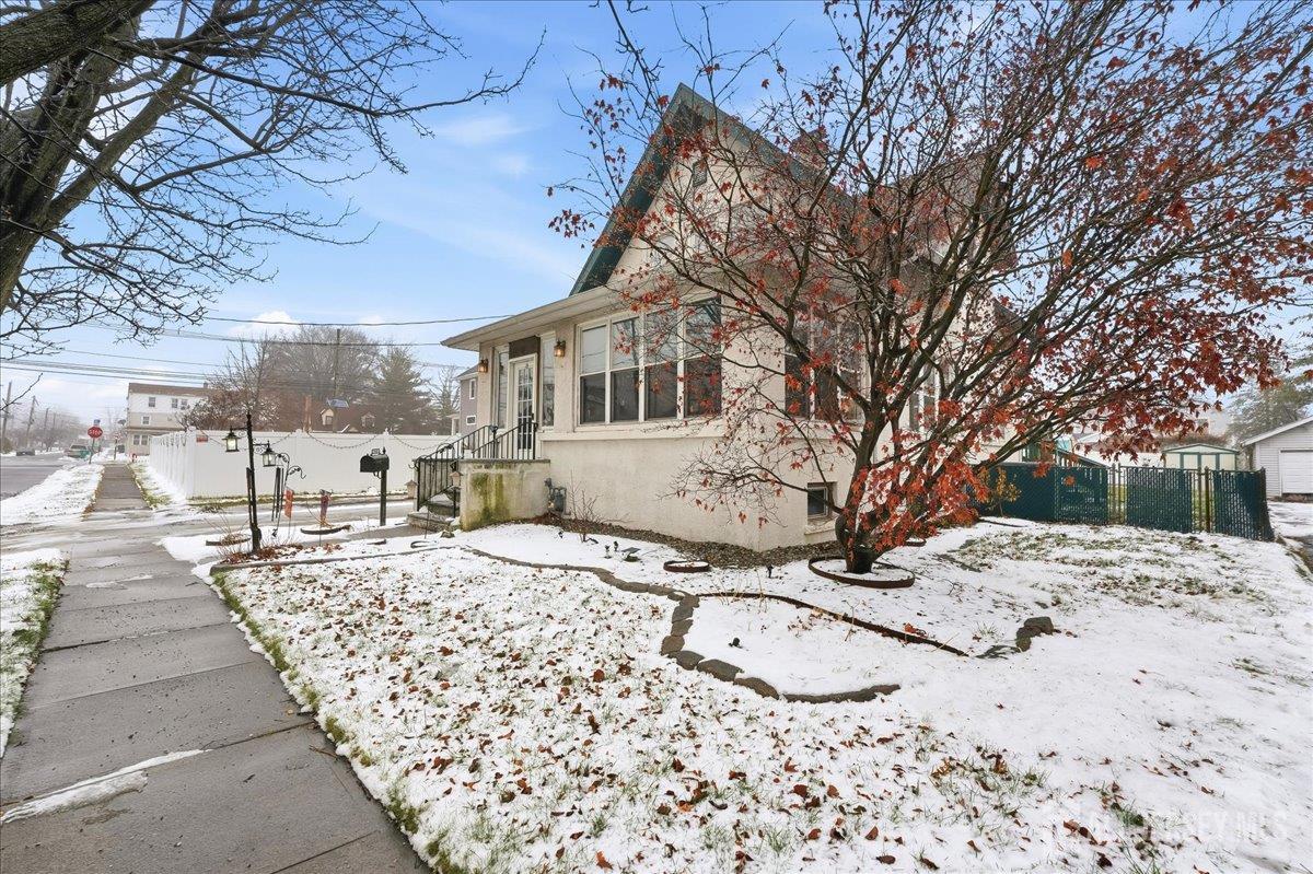 48 Bloomfield Avenue Edison, NJ 08837 - Photo 3 of 21 a front view of a house with a yard covered in snow