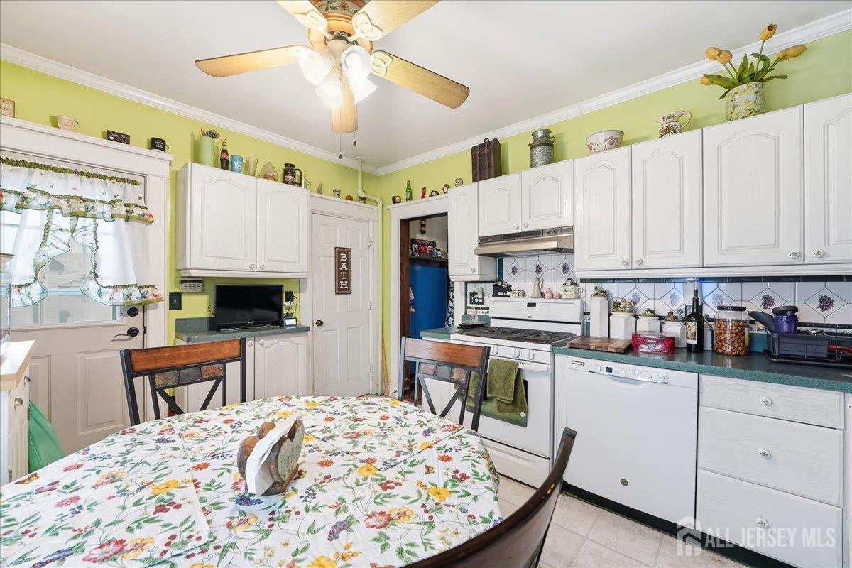 48 Bloomfield Avenue Edison, NJ 08837 - Photo 9 of 21 a kitchen with stainless steel appliances kitchen island granite countertop a stove a sink dishwasher and white cabinets with wooden floor