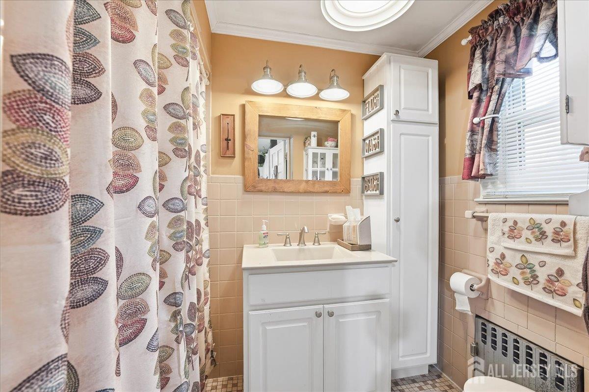 48 Bloomfield Avenue Edison, NJ 08837 - Photo 10 of 21 a bathroom with a sink and a mirror